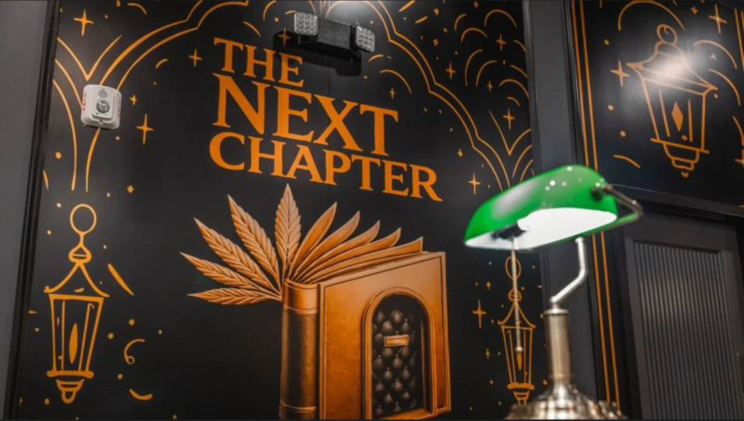 The Next Chapter Market — branded feature wall and reading lamp